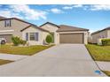 One-story house with a two-car garage and landscaped yard at 9433 Channing Hill Dr, Sun City Center, FL 33573