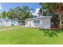 Newly renovated home with a well-manicured lawn and walkway at 3410 E Shadowlawn Ave, Tampa, FL 33610