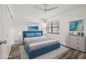 Comfortable staged bedroom with a blue bed frame, soft lighting, and a calming ambiance at 14130 Rosemary Ln # 2208, Largo, FL 33774