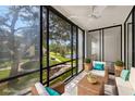 Cozy sunroom with views of the landscaped grounds and serene lake, perfect for relaxation at 14130 Rosemary Ln # 2208, Largo, FL 33774