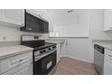 Modern kitchen with stainless steel appliances and light cabinets at 18001 Richmond Place Dr # 122, Tampa, FL 33647