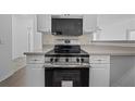 Modern kitchen with stainless steel appliances and light cabinets at 18001 Richmond Place Dr # 122, Tampa, FL 33647