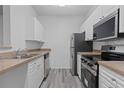 Bright kitchen featuring stainless steel appliances and white cabinets at 18001 Richmond Place Dr # 511, Tampa, FL 33647
