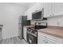 Modern kitchen with stainless steel appliances and white cabinets at 18001 Richmond Place Dr # 511, Tampa, FL 33647