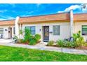 Exterior view of a condo with landscaped garden at 1619 Mission Hills Blvd, Clearwater, FL 33759