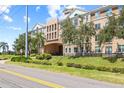 Apartment building with a stone facade, landscaping, and ample parking at 4221 W Spruce St # 1424, Tampa, FL 33607