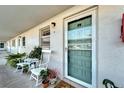 Quaint condo entrance with rocking chairs and lush greenery at 5286 81St N St # 4, St Petersburg, FL 33709