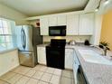 Condo kitchen with stainless steel appliances and granite countertops at 1408 Millstream Ln # 102, Dunedin, FL 34698