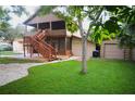 Two-story house with wooden exterior, deck, and detached garage at 10213 Newport Cir, Tampa, FL 33612