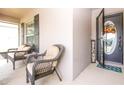 Relaxing front porch with wicker chairs and a welcoming entrance at 729 Vineyard Reserve Ct, Seffner, FL 33584