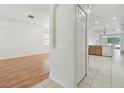 Bright hallway with hardwood floors and archways leading to other rooms at 3232 Gianna Way, Land O Lakes, FL 34638