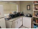 Kitchen features white cabinets and a granite countertop at 1528 Stevensons Dr, Clearwater, FL 33755