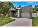 Modern gray house with a covered porch and driveway at 2604 N 29Th St, Tampa, FL 33605
