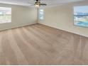 Bright and airy bedroom with neutral carpeting and large windows at 4417 Shrewbury Pl, Land O Lakes, FL 34638