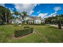 Stunning curb appeal with lush landscaping at 180 Keystone Palms Blvd, Tarpon Springs, FL 34688