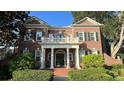 Brick two-story house with white columns and a balcony at 29731 Chapel Park Dr, Wesley Chapel, FL 33543