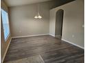 The open dining room is bright with wood floors and plenty of space for entertaining at 12161 Cavern Rd, Spring Hill, FL 34609