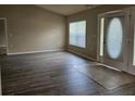 Inviting living room showcasing wood floors, neutral paint, and bright natural light at 12161 Cavern Rd, Spring Hill, FL 34609