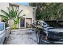Modern building exterior with lush tropical landscaping and electric vehicle charging station at 1905 E Mulberry Dr # 1, Tampa, FL 33604