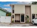 Front view of a two-story house with a black door and landscaping at 1905 E Mulberry Dr # 2, Tampa, FL 33604