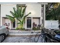 Modern building exterior with lush tropical landscaping and electric vehicle charging station at 1905 E Mulberry Dr # 1, Tampa, FL 33604