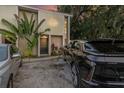 Modern building exterior with lush tropical landscaping and electric vehicle charging station at 1905 E Mulberry Dr # 1, Tampa, FL 33604