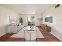 Living room with wood floors and access to patio at 7585 Abonado Rd, Tampa, FL 33615
