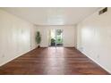 Spacious living room with wood floors and patio access at 7585 Abonado Rd, Tampa, FL 33615