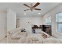 Bright living room featuring a comfy sofa, large TV, and ceiling fan at 1404 E Frances Ave, Plant City, FL 33563