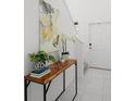 Bright entryway with console table, art, and plants at 6267 Back Forty Loop, Zephyrhills, FL 33541