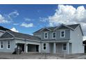 Two-story home with gray siding, large windows, and attached two-car garage at 16227 Alpha Grove Pl, Odessa, FL 33556