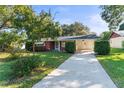 Brick ranch home with a carport and well-manicured lawn at 5824 11Th St, Zephyrhills, FL 33542