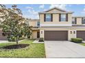 Two-story house with brown garage door and landscaping at 8514 Zapota Way, Tampa, FL 33647