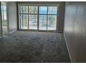 Living room with sliding glass doors leading to balcony and ocean view at 6322 Palma Del Mar S Blvd # 215, St Petersburg, FL 33715