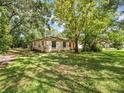 Cozy single-story home with a well-maintained lawn and mature trees offering ample shade at 26831 Chianina Dr, Wesley Chapel, FL 33544