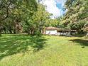 House nestled in a spacious, tree-filled yard at 26831 Chianina Dr, Wesley Chapel, FL 33544