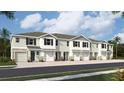 Modern townhouses with attached garages and neutral colors at 11408 Crescent Deer Dr, Land O Lakes, FL 34638