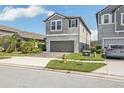 Two-story house with gray siding, two-car garage, and a fire hydrant nearby at 2848 Gridiron Isle, New Port Richey, FL 34655