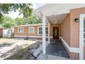 Inviting front porch with white columns and a wood door at 2121 23Rd Sw St, Largo, FL 33774