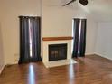 Living room with hardwood floors and a fireplace at 10908 Claymont Dr, New Port Richey, FL 34654