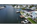 Aerial view of waterfront home with private dock and boat, showcasing the surrounding neighborhood at 160 174Th Terrace E Dr # A, Redington Shores, FL 33708