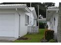 Side view of a white single story home and garage at 4166 96Th N Ter # 4166, Pinellas Park, FL 33782