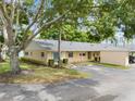 Tan single story home with green shutters and a spacious yard at 2465 Northside Dr # 701, Clearwater, FL 33761