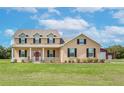 Two-story house with a red door and barn at 8703 Alafia Hills Dr, Plant City, FL 33567