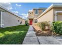 Landscaped front yard with a walkway to the house entrance at 20270 Merry Oak Ave, Tampa, FL 33647