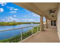 Serene balcony view overlooking a tranquil lake with a fountain feature and lush greenery at 43 Bayview S Ct # A, St Petersburg, FL 33711