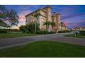 Stunning exterior view of a multi-story condo building with lush landscaping and palm trees at 43 Bayview S Ct # A, St Petersburg, FL 33711