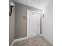 White door entry to condo unit with neutral wall tones and carpet at 1 Beach Se Dr # 1208, St Petersburg, FL 33701