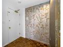 Condo entry with patterned wallpaper and wood flooring at 1 Beach Se Dr # 1208, St Petersburg, FL 33701
