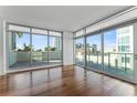 Bright living room with hardwood floors and sliding glass doors leading to a balcony at 912 Channelside Dr # 2607, Tampa, FL 33602